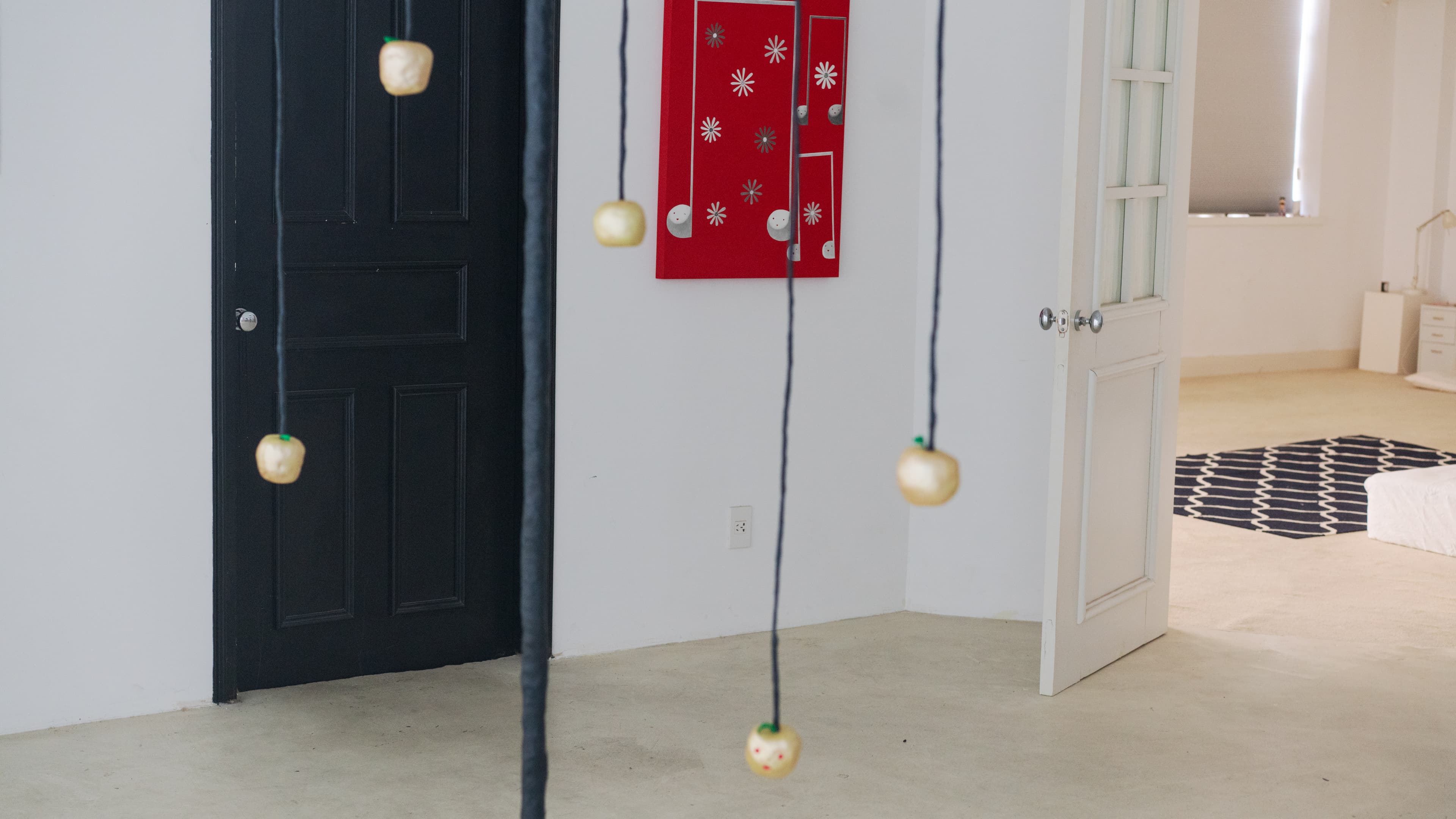 Hanging sculptures near an open doorway in Rui Wang's studio