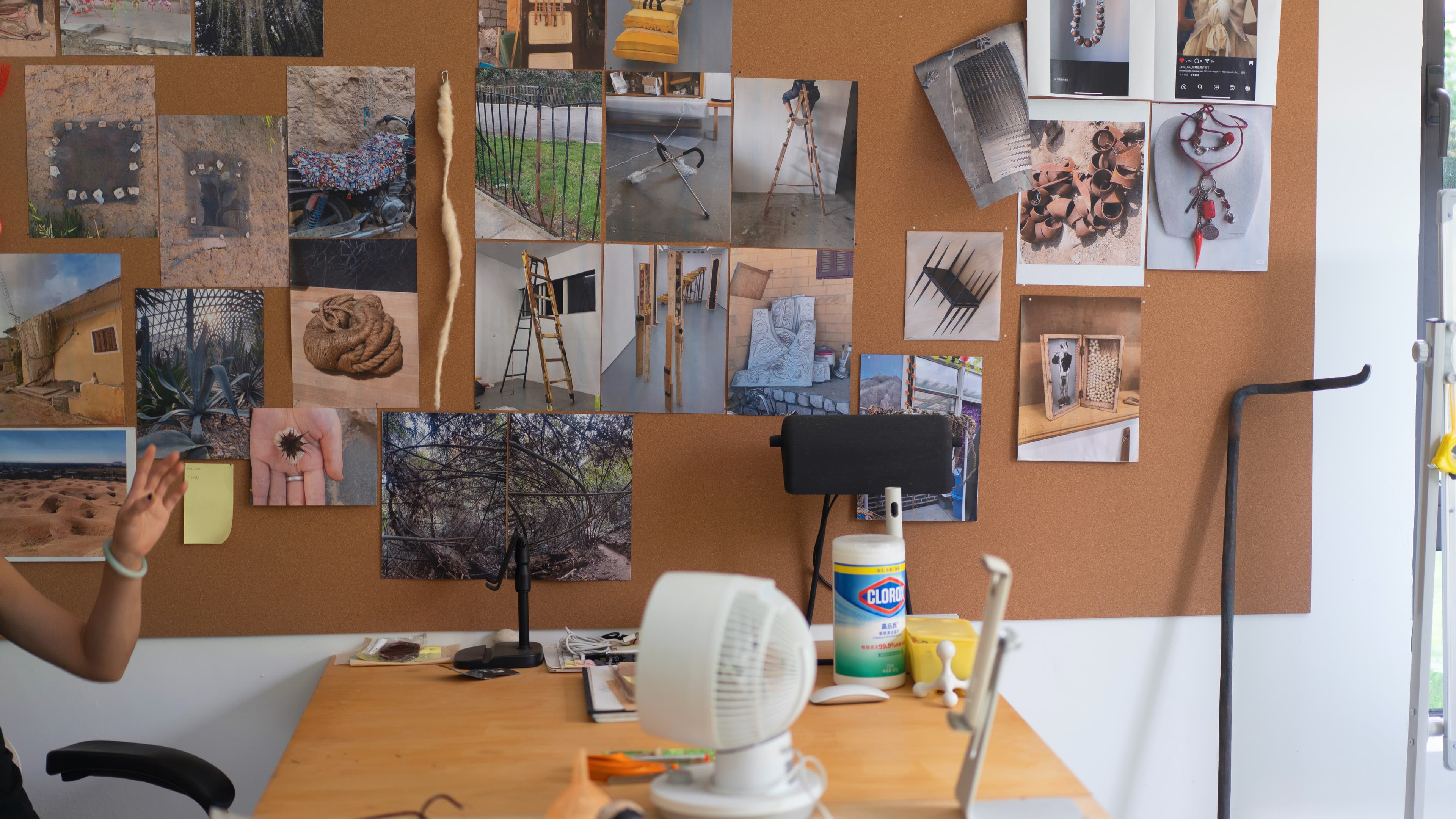 Photographs and references pinned to a wall in Xue Ying's studio